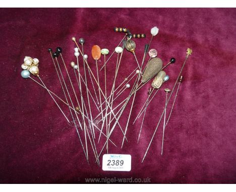 A quantity of hat pins to include; polished stone, simulated pearl, etc.