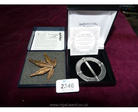 A Pewter scarf ring by Lady Crow Silks and a maple leaf shaped brooch by Leaves of Gold.