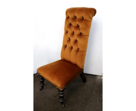 A Victorian button down upholstered prie dieu chair, circa 1840, on turned faux rosewood legs and castors, 105cm high.