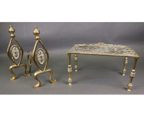 A pair of Art Nouveau brass fire dogs, a set of three George III style brass fire tools and a pierced brass footman, 19th cen