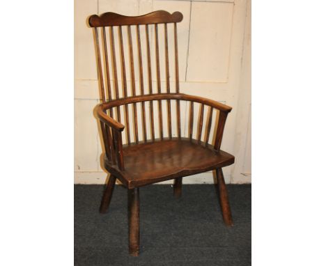 A Windsor comb back armchair with semi-circular seat, on turned legs