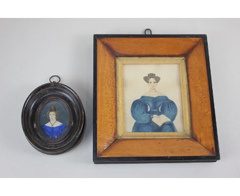 A 19th century miniature portrait of a lady with tightly curled hair, wearing a blue gown, holding a book, faded inscription 