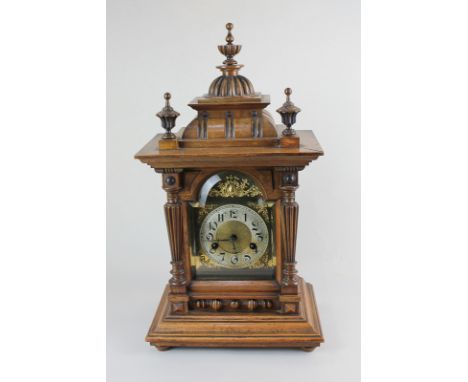 An early 20th century HAC (Hamburg Amerikanische Uhrenfabrik) German oak cased mantel clock, the domed face with gilt spandre
