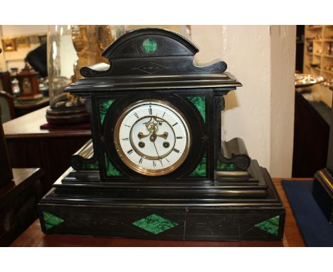 A Victorian black slate mantel clock, the dial with Roman numerals and exposed escapement, the movement stamped S Marti et Ci