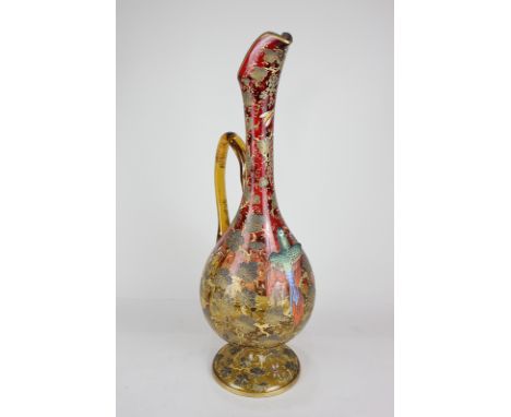 An unusual 19th century large coloured glass jug with central raised parrot design with gilt fruiting vines and painted insec