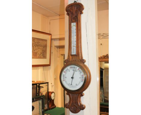 A carved oak aneroid wheel barometer, with thermometer, 91cm, (a/f)