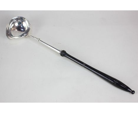 A George III silver punch ladle with turned wood handle, marks rubbed, 37cm