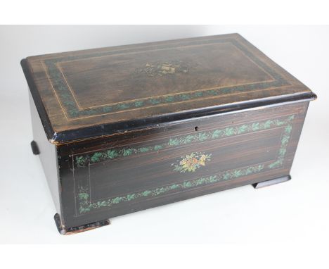 A 19th century Swiss music box, with lacquered decoration, plays six airs on comb and cylinder, bells and drum in sight, chan