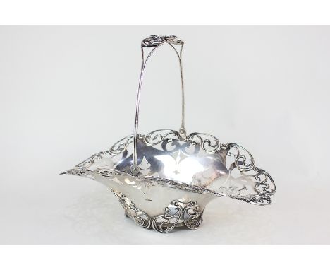 An American sterling silver basket, oval form with scroll pierced border and swing handle, stamped C D Peacock, sterling to b