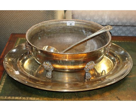 A silver plated oval tureen with lion mask ring handles, raised on cast paw feet, 38cm, a large oval serving dish, 60cm, and 