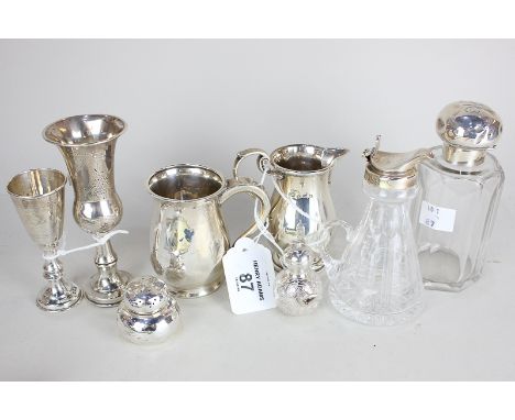 A George V silver cream jug with scroll handle, Birmingham 1926, a small mug, two small goblets with engraved decoration, a c