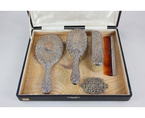 An Edward VII silver mounted dressing table set of hand mirror, hair brush, comb and clothes brush, maker William Comyns & So