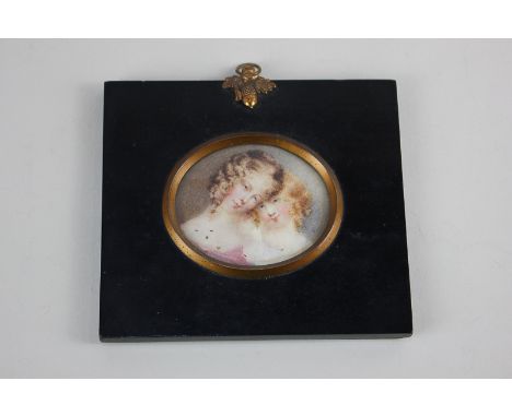 An oval miniature portrait depicting two girls, 5.7cm by 6.7cm, the frame stamped verso 'Walter Jones Sloane Street'