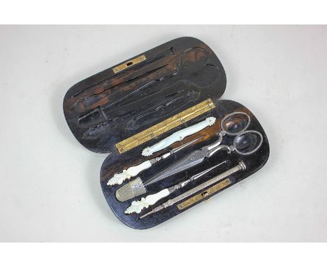 A sewing set in fitted Coromandel case, to include an S Mordan & Co pencil, J Rodgers & Sons scissors, and three tools with m