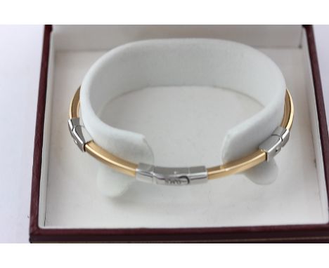 An Italian 18ct rose and white gold hinged bangle, 16g gross