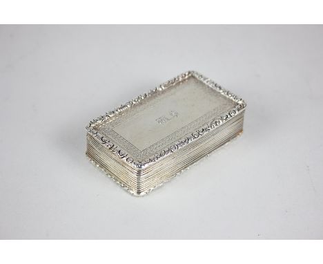 A Victorian silver snuff box, rectangular shape with reeded sides, hinged lid with scroll cast border, with engraved initials