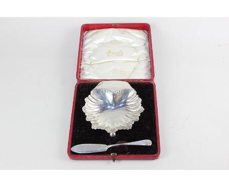 An Edward VII silver shell shaped butter dish and knife set, cased, maker Henry Wilkinson & Co Ltd, London 1904, 2.5oz