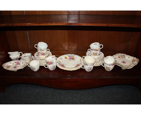 A Royal Crown Derby porcelain part tea set in the Derby Posies pattern, comprising eleven teacups, twelve saucers, eleven tea