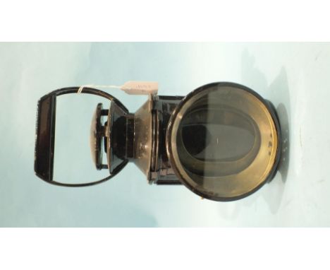 A Japanned four-aspect hand lamp with burner, reservoir, reflector and all four glasses.
