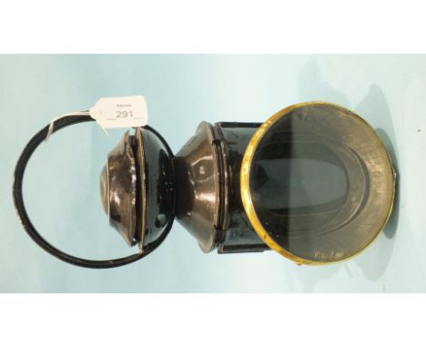 A black-painted LNER four-aspect hand lamp with burner, reservoir, reflector and all glasses, marked 'Kerosene'.