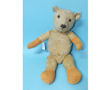 A teddy bear c1940's, possibly a Chiltern Hugmee, with clear and black glass eyes, vertically-stitched nose, growler and blon