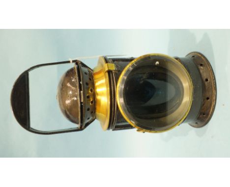 A black-painted three-aspect railway hand lamp by Eli Griffiths & Sons, with burner, reservoir, reflector and glasses, with a