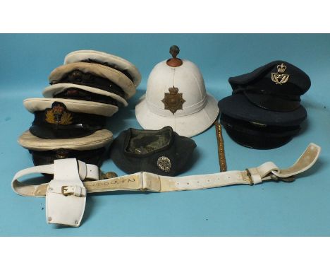 A Royal Marines helmet and belt, five Royal Navy caps, two RAF caps, a beret, a German Ensign flag and three other flags, (on