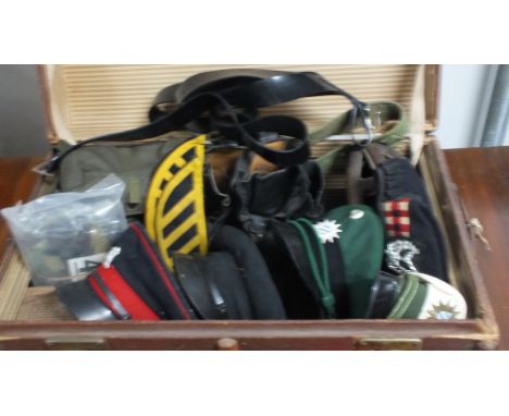 A quantity of mainly British Army items including a 1939 helmet, two pairs of boots, two gas masks, two glengarry hats and ot
