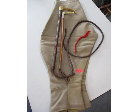 A pair of vintage riding breeches and two horn handled crops 