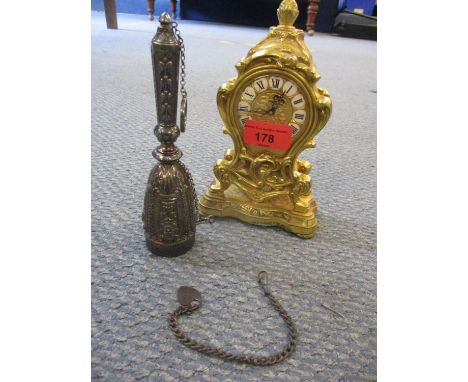 A reproduction Louis XV Swiss movement gilt mantle clock, 18cm high, together with a silver metal hair piece and a chain with