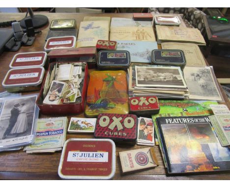 Cigarette cards and postcards to include those depicting mainly trains and a selection of vintage tins 