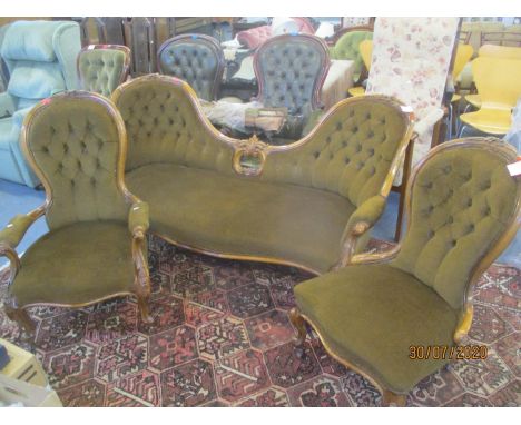 A Victorian walnut carved salon sofa, together with a pair of matching spoon back armchairs 