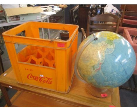 A vintage globe raised on a circular swivel base, together with a vintage Cola Cola crate 