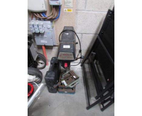 A pedestal drill and other tools