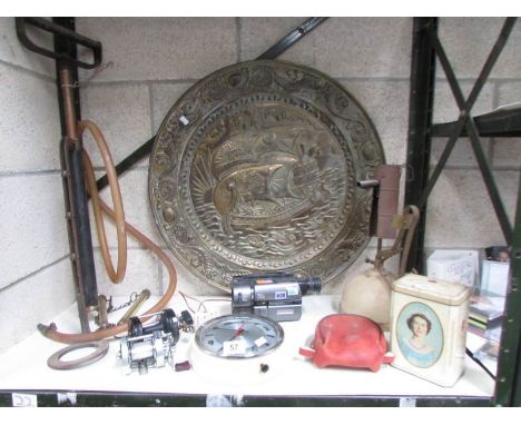 A mixed lot including fishing reels, brass plaque, wall clock, stirrup pump, blow torch etc