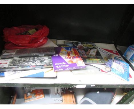 A shelf of art items including paints