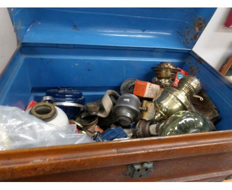 A tin trunk full of oil lamp parts