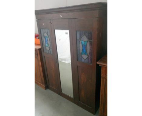 An art nouveau wardrobe with leaded glass decoration (missing base)