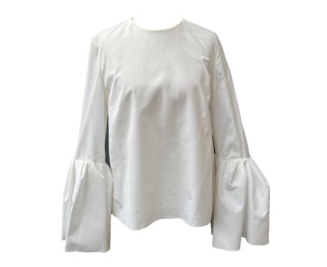 A Roksanda white cotton blouse with ruffle cuffs and darts to bust, zip closure to back, size 10