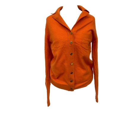 An Hermes cashmere cardigan in citrus orange, gold toned buttons with collar, breast pocket, made in Scotland, size M