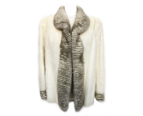 A pearl mink fur jacket by National Fur Company, with grey and ivory striped collar and cuff, sleeves with slight bishop shap