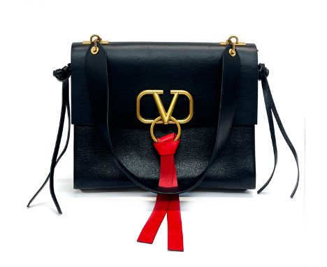 A Valentino Garavani Vlogo/Vring black leather handbag with red leather tie tassel, one shoulder length strap, two large comp