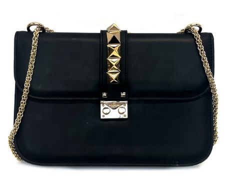 A Glam Lock Valentino Garavani black leather handbag with gold toned adjustable chain and rockstud hardware, two external poc
