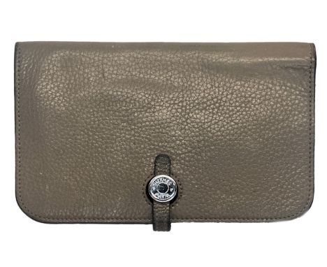 A Hermes Dogon leather purse in clay, with silver toned Hermes imprint hardware closure, two large internal compartments, and