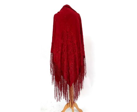 An early 20th century red silk piano shawl with floral embroidered detail (AF), knotted and tasseled fringe, 57.5" width