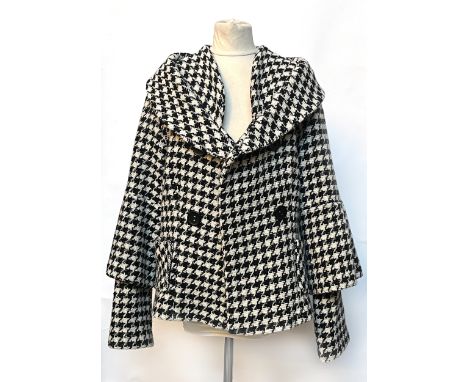 A houndstooth jacket with tiered sleeves, chest 37", by Eva Travalala Paris, together with a double collar white shirt in sat