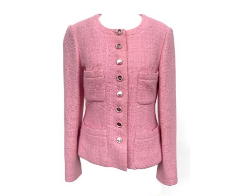 A pink Chanel jacket in boucle tweed, with CC monogram buttons, collarless round neck, four patch pocket to front, 100% wool 