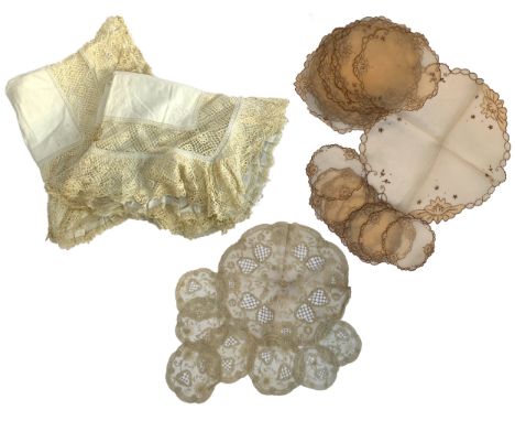 A quantity of early 20th century table and bed textiles, to include two lace frill pillowcases, two sets of embroidered silk 