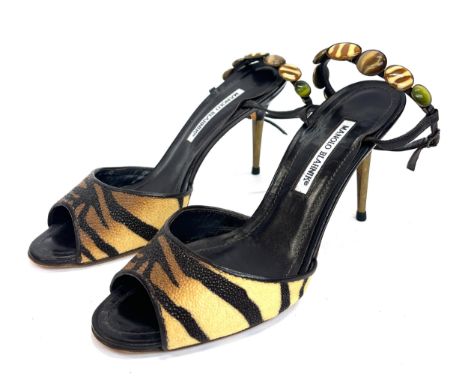 A pair of Manolo Blahnik high heeled sandals, reptile skin textured strap in tiger print, with ankle strap embellished with g