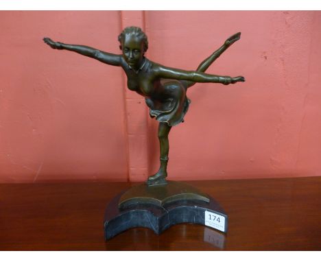 An Art Deco style bronze figure of a female skater, on black marble socle